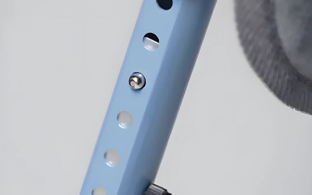 Close-up of a frame leg: a push button in a row of holes sets the height