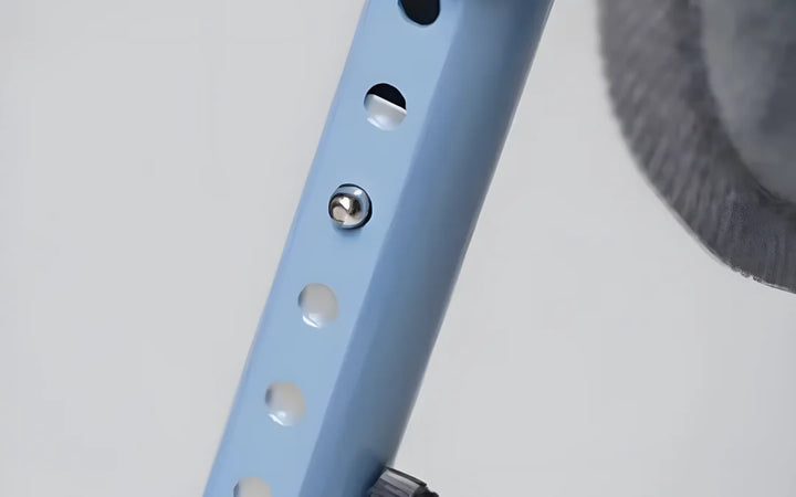 Close-up of a push button in a row of holes that sets the height